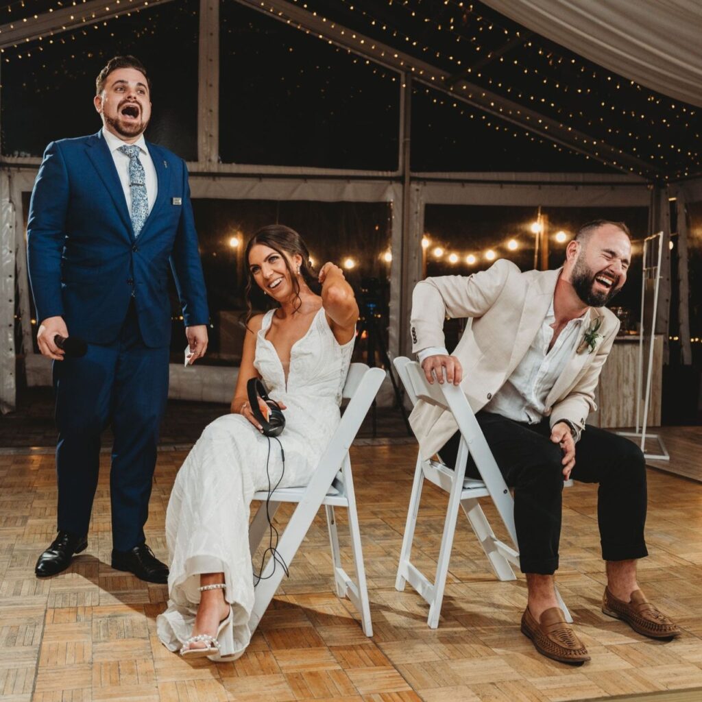Bride and groom laughing during wedding reception game
