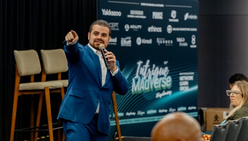 Nathan Cassar, corporate event mc in blue suit presenting at Sydney conference