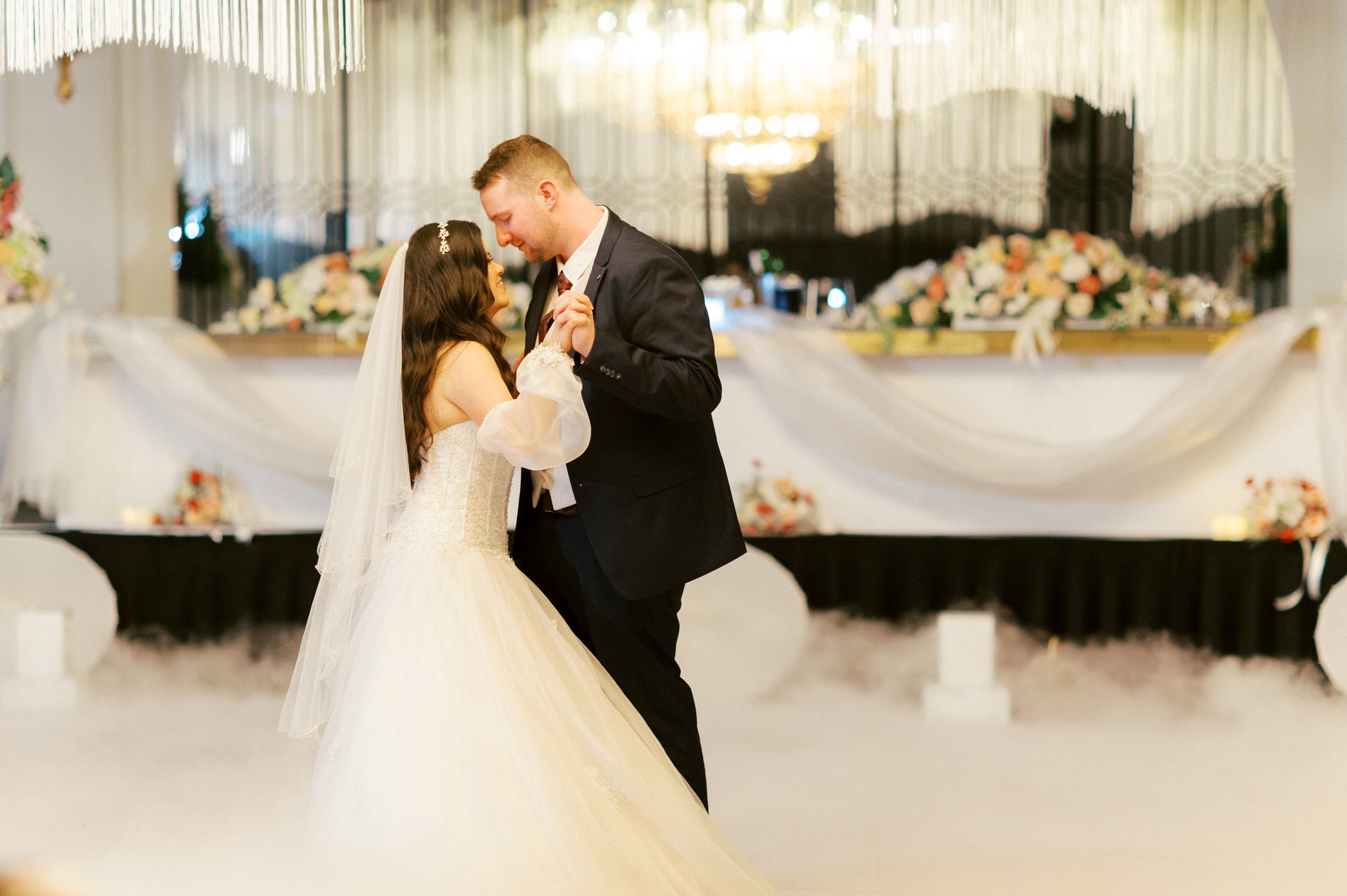 Bride and groom sharing first dance at reception