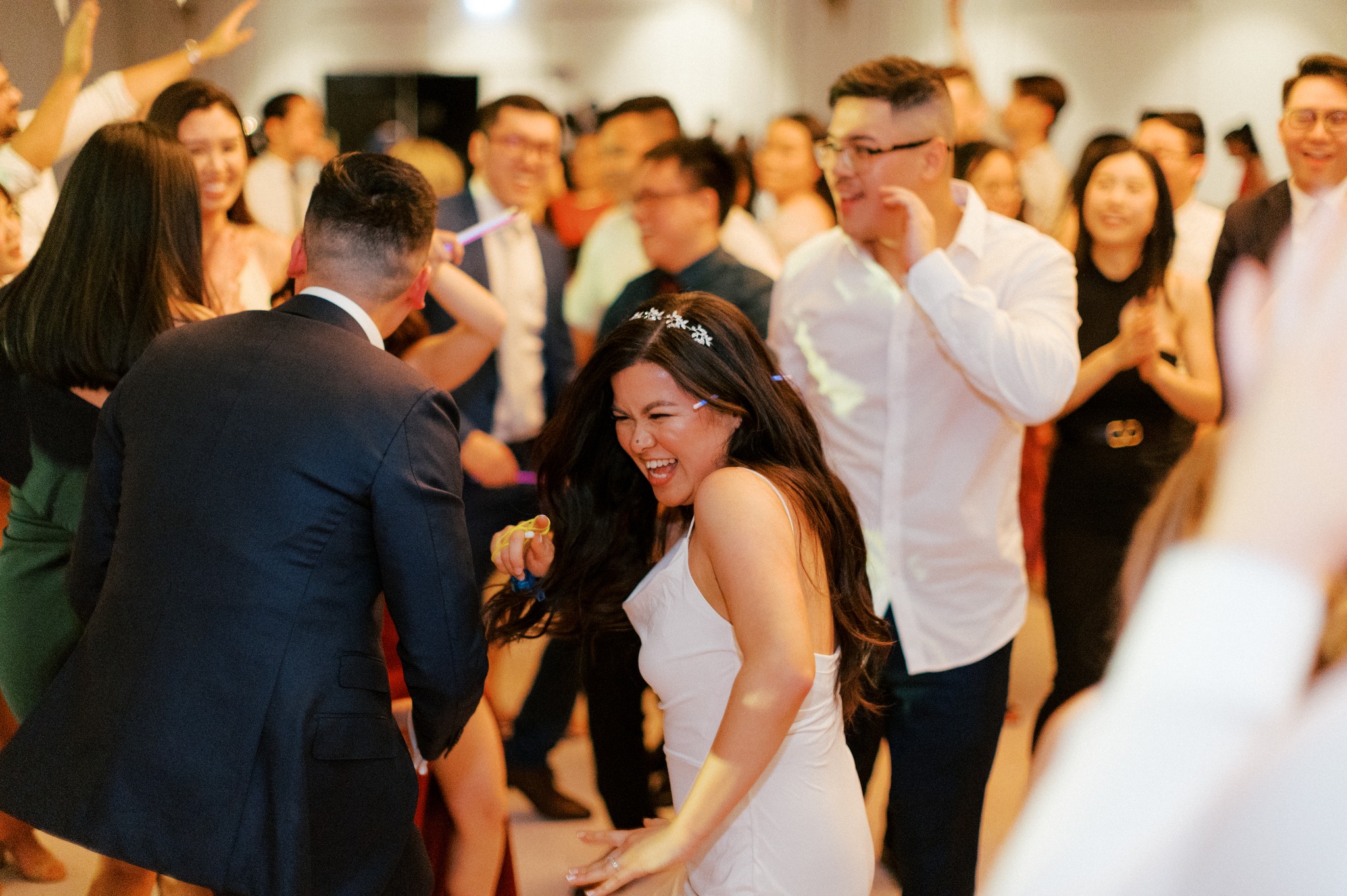 Bride dancing joyfully with guests at reception