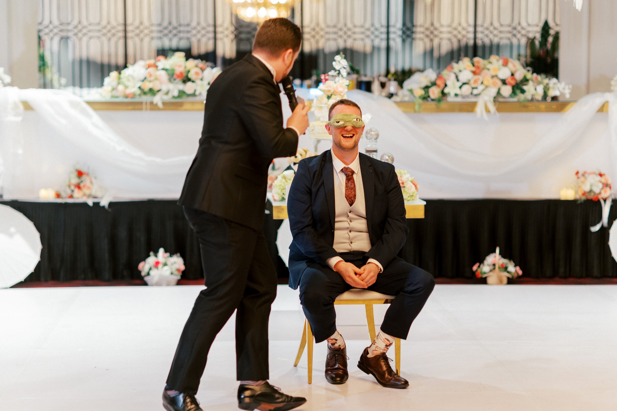Groom blindfolded during wedding reception game