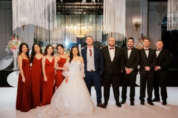 Bride and groom with bridal party indoors elegant wedding venue