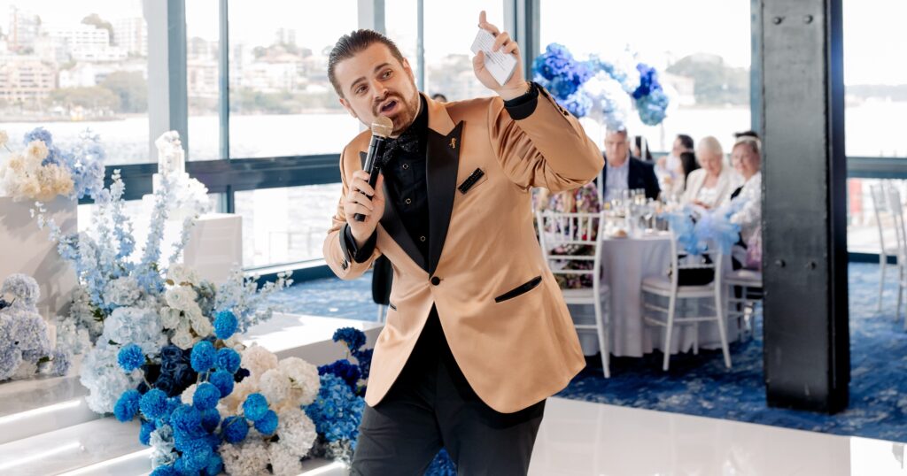 MC speaking at waterfront wedding reception venue