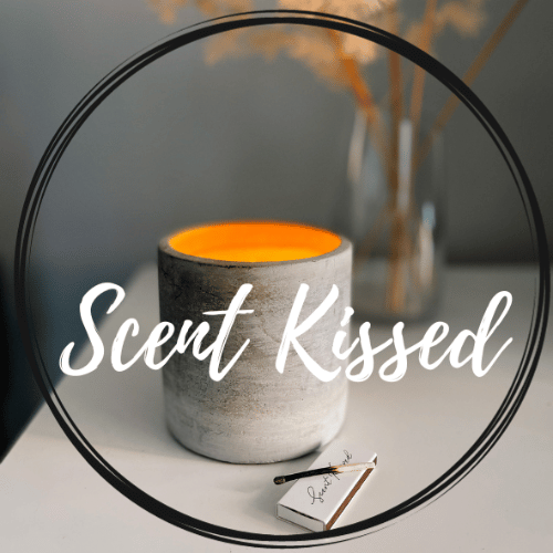 Lit candle with Scent Kissed text overlay